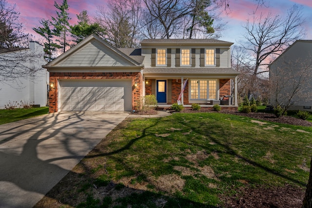 traditional-style home featuring brick siding, a garage, a porch, a yard, and driveway
