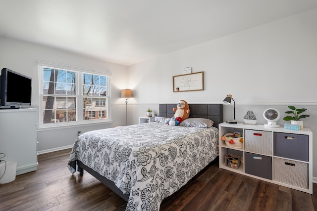 bedroom featuring baseboards and wood finished floors