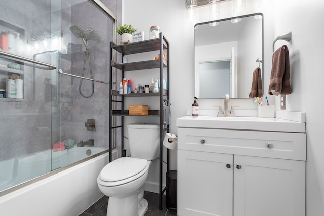 bathroom featuring vanity, shower / bath combination with glass door, and toilet