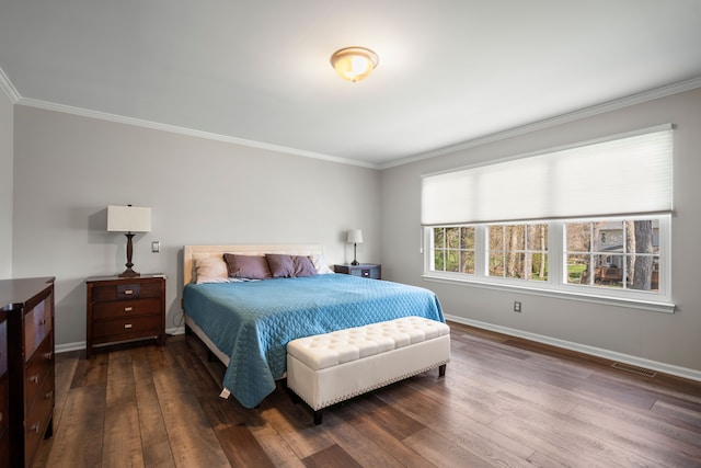 bedroom with baseboards, ornamental molding, dark wood-style flooring, and visible vents