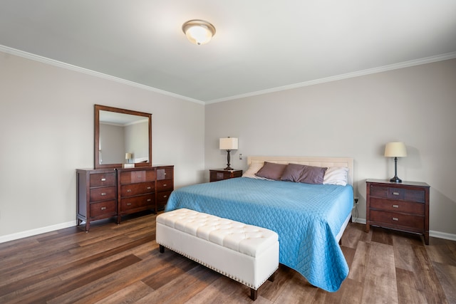 bedroom with crown molding, baseboards, and wood finished floors