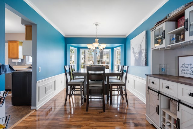 dining space with an inviting chandelier, a healthy amount of sunlight, and a decorative wall