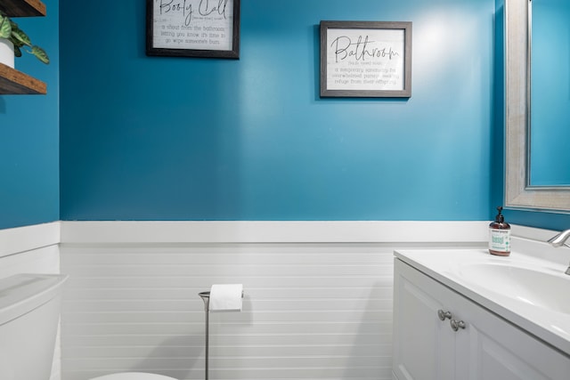 half bathroom featuring toilet and vanity