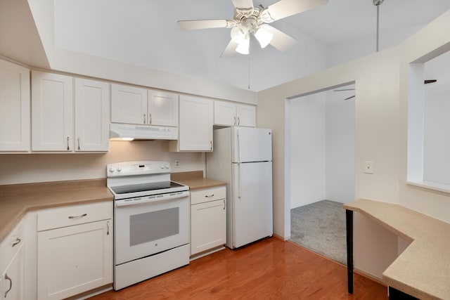 kitchen featuring white appliances, white cabinetry, under cabinet range hood, and light countertops