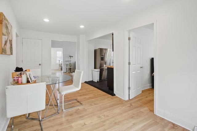 dining room with recessed lighting, baseboards, and light wood-type flooring
