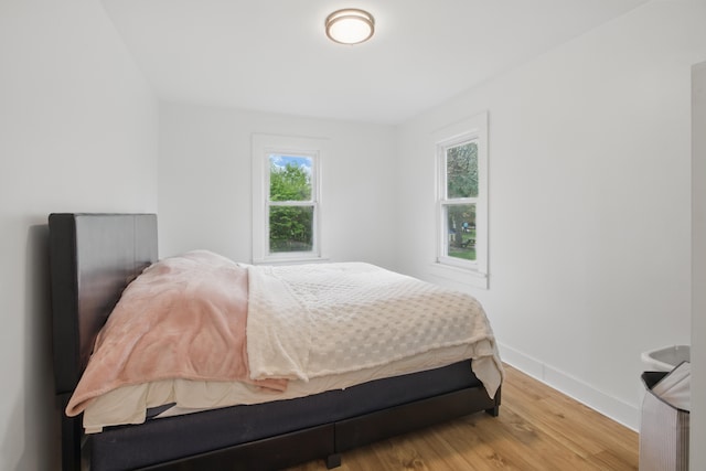 bedroom featuring baseboards and wood finished floors