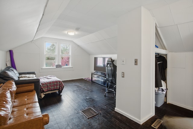 bedroom with baseboards, visible vents, dark wood-style floors, and lofted ceiling