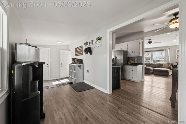 1128 Braeview Dr, Howell, MI 48843 - kitchen with ceiling fan, dark wood finished floors, baseboards, open floor plan, and white cabinets