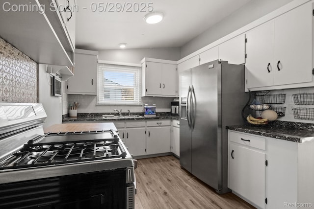 1128 Braeview Dr, Howell, MI 48843 - kitchen with range with gas stovetop, a sink, stainless steel refrigerator with ice dispenser, light wood-style floors, and backsplash