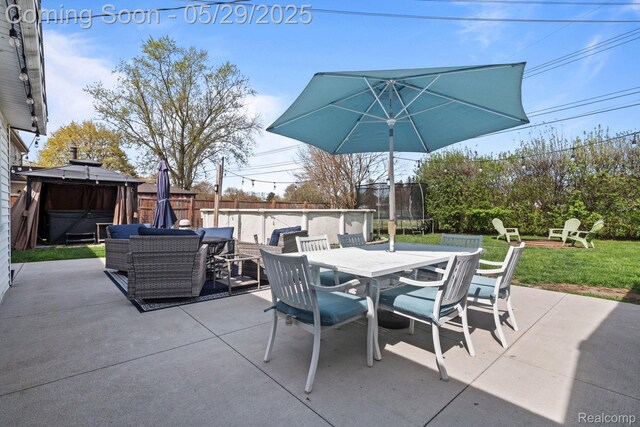 1128 Braeview Dr, Howell, MI 48843 - view of patio featuring outdoor dining area, a gazebo, a trampoline, and an outdoor fire pit