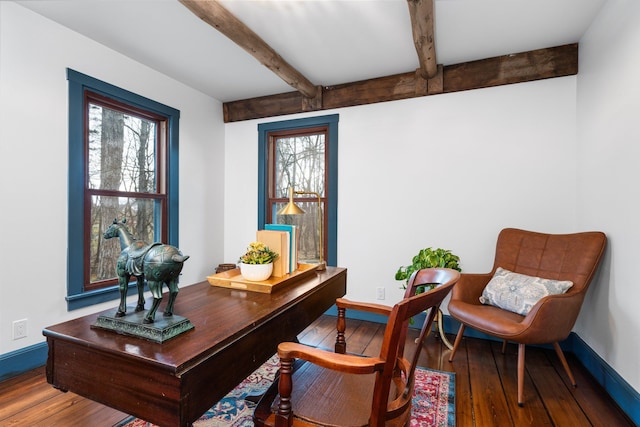 office space with baseboards, plenty of natural light, beamed ceiling, and hardwood / wood-style flooring