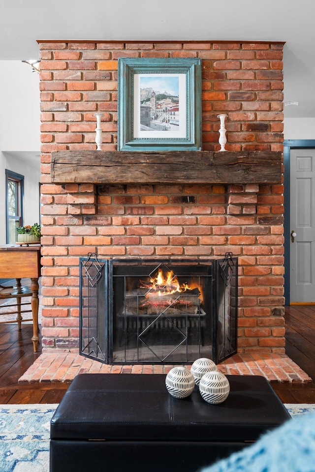 interior details featuring a fireplace and wood finished floors