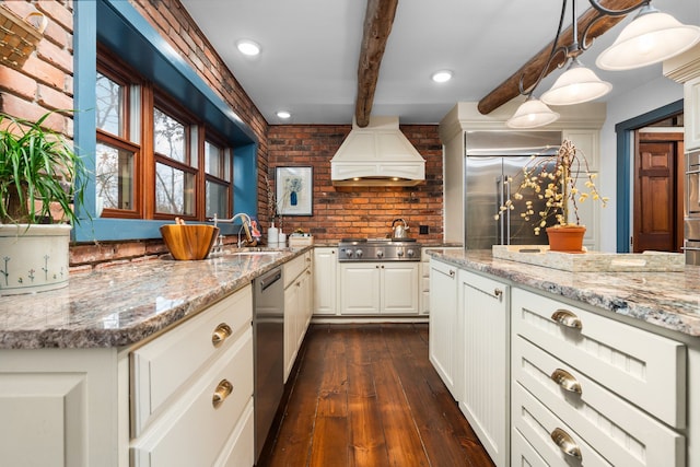 kitchen featuring beam ceiling, premium range hood, a sink, dark wood finished floors, and stainless steel appliances