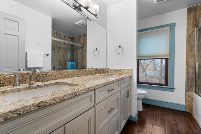 bathroom with visible vents, a sink, and tiled shower
