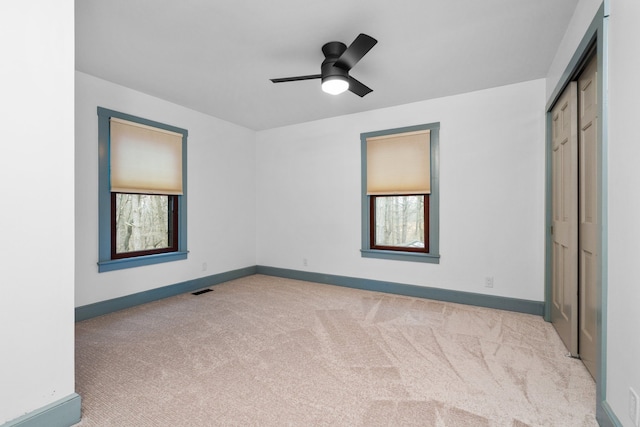 unfurnished bedroom with baseboards and light carpet