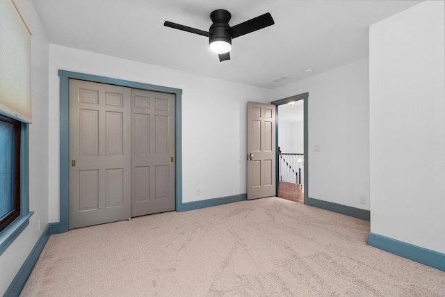 unfurnished bedroom with baseboards, carpet, and ceiling fan