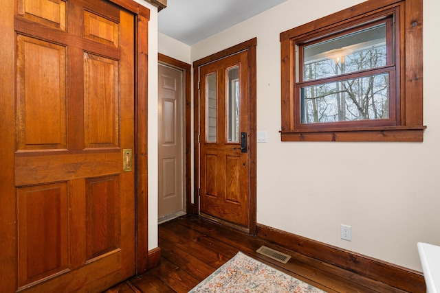 entrance foyer with baseboards, dark wood finished floors, and visible vents