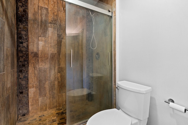 full bath with a stall shower and toilet