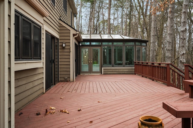 deck with french doors and a sunroom