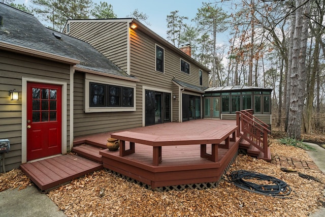 wooden terrace featuring a sunroom