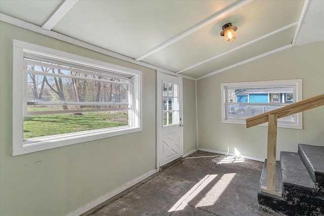 entrance foyer featuring baseboards, vaulted ceiling, and stairway