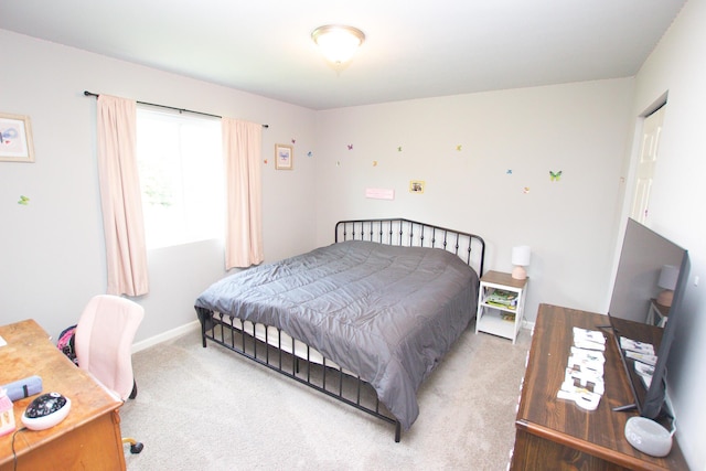 bedroom with carpet floors and baseboards