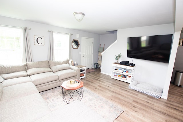 living room featuring baseboards and wood finished floors