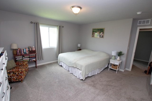 carpeted bedroom featuring baseboards and visible vents