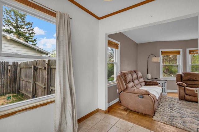 sitting room featuring baseboards, crown molding, and tile patterned flooring