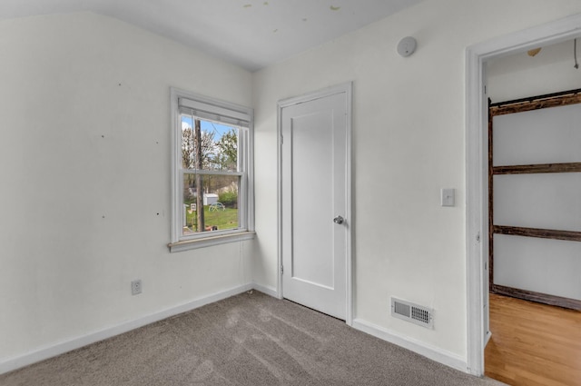 unfurnished bedroom with baseboards, carpet floors, and visible vents