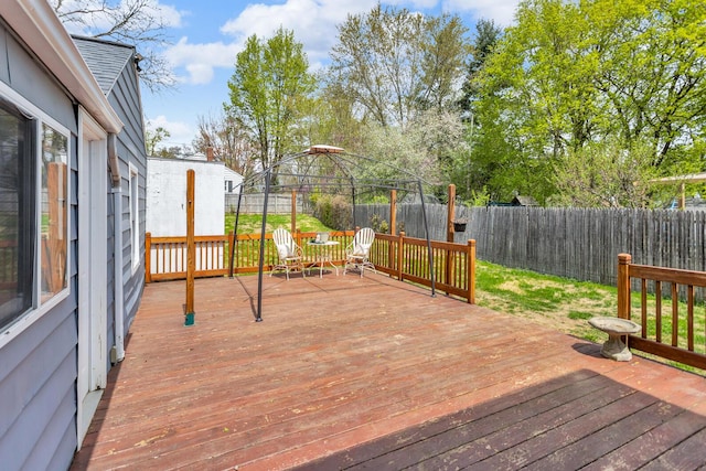 wooden terrace with a fenced backyard and a gazebo