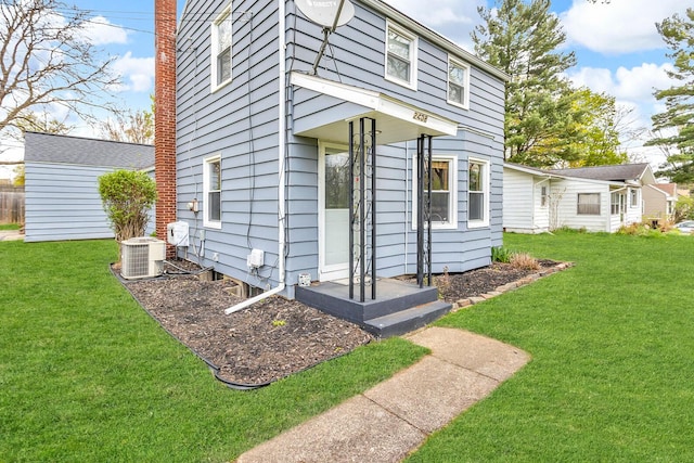 2408 Cobb Rd, Jackson, MI 49203 - property entrance with a yard and cooling unit