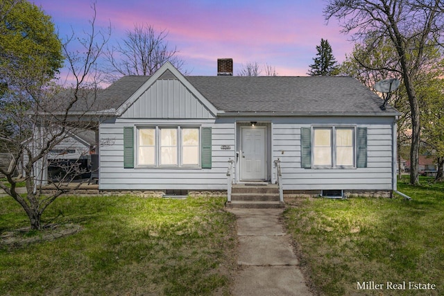 729 E Madison St, Hastings, MI 49058 - bungalow featuring a shingled roof, a front lawn, and a chimney