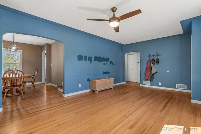 729 E Madison St, Hastings, MI 49058 - interior space featuring arched walkways, ceiling fan, visible vents, and light wood-style flooring