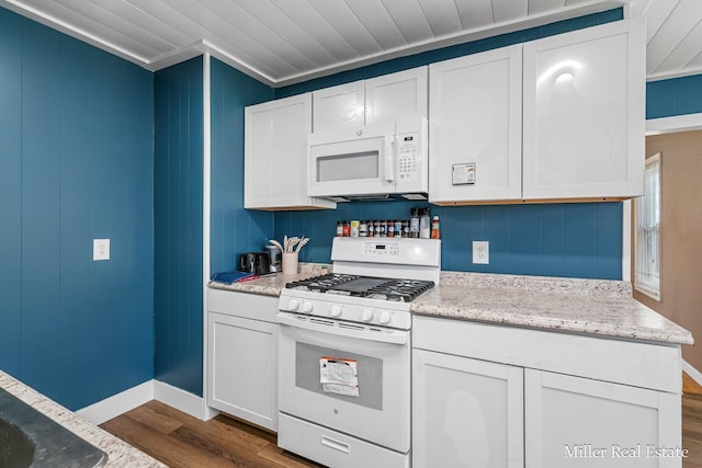729 E Madison St, Hastings, MI 49058 - kitchen featuring dark wood-style flooring, crown molding, light stone countertops, white appliances, and white cabinetry
