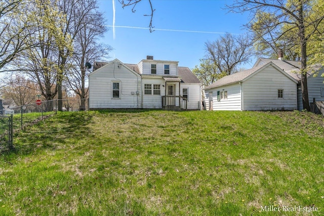 729 E Madison St, Hastings, MI 49058 - rear view of house with a yard, fence, and a chimney