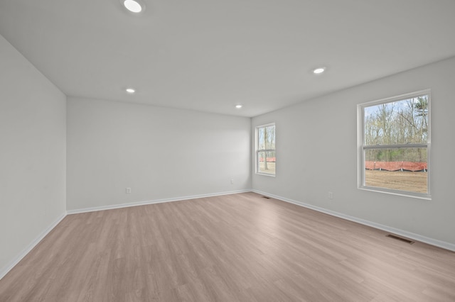 spare room featuring recessed lighting, baseboards, visible vents, and light wood-type flooring