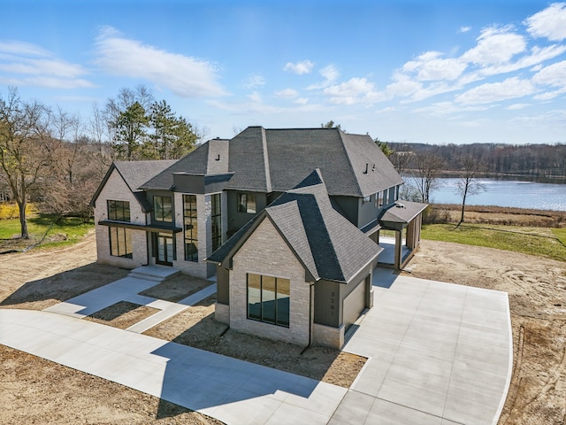 3281 Chickering Ln, Bloomfield Hills, MI 48302 - back of property with roof with shingles, a water view, stone siding, and concrete driveway