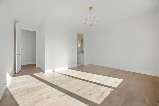 3281 Chickering Ln, Bloomfield Hills, MI 48302 - empty room with a chandelier, light wood finished floors, and baseboards