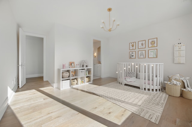 3281 Chickering Ln, Bloomfield Hills, MI 48302 - bedroom featuring a chandelier, wood finished floors, and a crib
