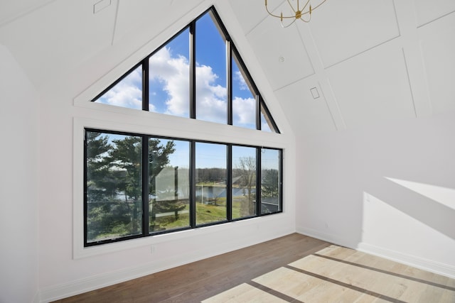 3281 Chickering Ln, Bloomfield Hills, MI 48302 - unfurnished room featuring plenty of natural light, a water view, wood finished floors, baseboards, and high vaulted ceiling