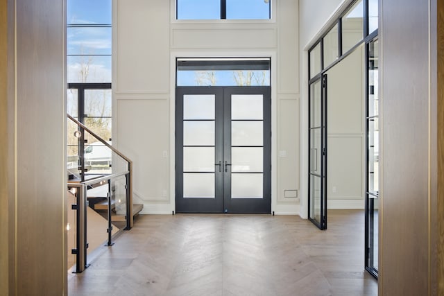 entrance foyer featuring a decorative wall and french doors
