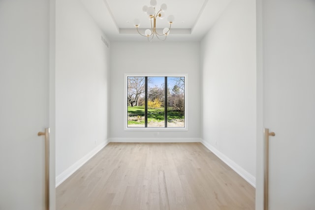 3281 Chickering Ln, Bloomfield Hills, MI 48302 - spare room with light wood-style floors, a raised ceiling, a chandelier, and baseboards