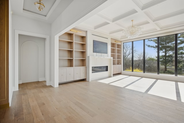 3281 Chickering Ln, Bloomfield Hills, MI 48302 - unfurnished living room with a chandelier, a glass covered fireplace, wood finished floors, built in features, and beam ceiling