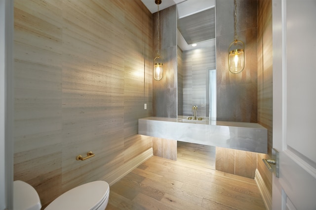 3281 Chickering Ln, Bloomfield Hills, MI 48302 - bathroom featuring toilet, wood finished floors, wood walls, and a sink