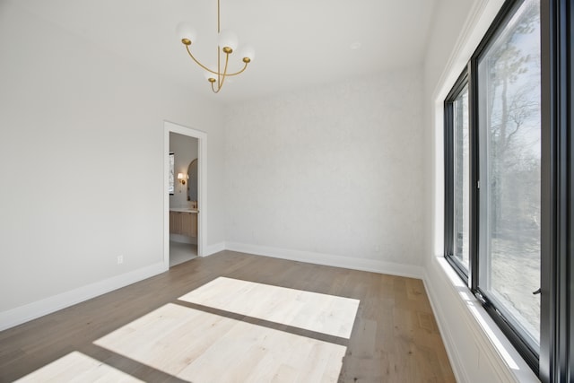 3281 Chickering Ln, Bloomfield Hills, MI 48302 - unfurnished room featuring plenty of natural light, a chandelier, wood finished floors, and baseboards