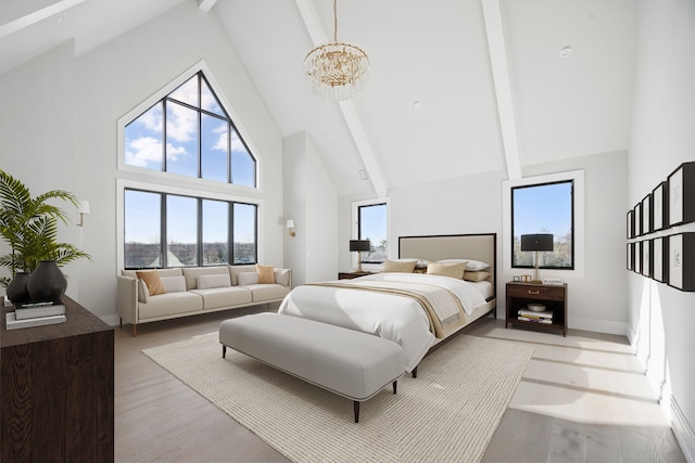 bedroom featuring high vaulted ceiling, beam ceiling, a chandelier, and light wood-style flooring