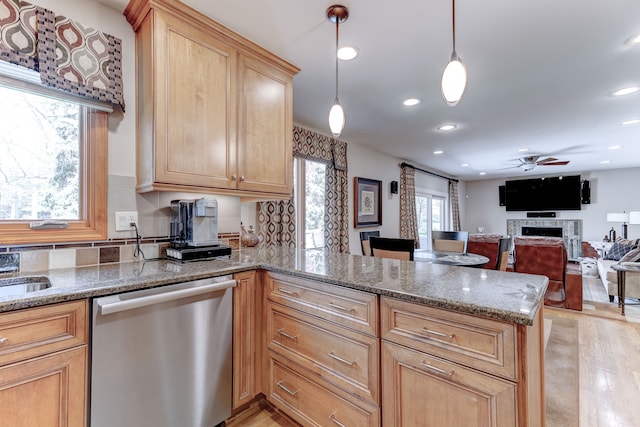 kitchen featuring a peninsula, a fireplace, recessed lighting, a ceiling fan, and dishwasher