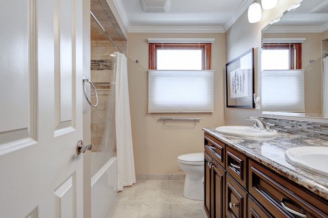 bathroom featuring a sink, crown molding, toilet, and a healthy amount of sunlight