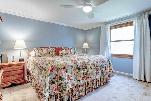carpeted bedroom featuring baseboards, ornamental molding, and ceiling fan